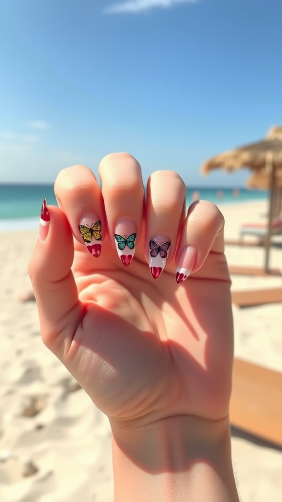 A hand showing butterfly nail designs at the beach with a clear blue sky.