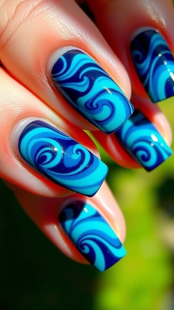 Nails painted in deep blue with swirling teal designs.