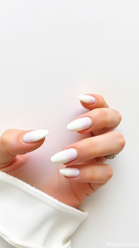 A close-up of hands with geometric French tip nails featuring white tips against a light background.