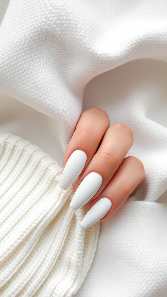 Close-up of a hand with matte white nails on a textured white background