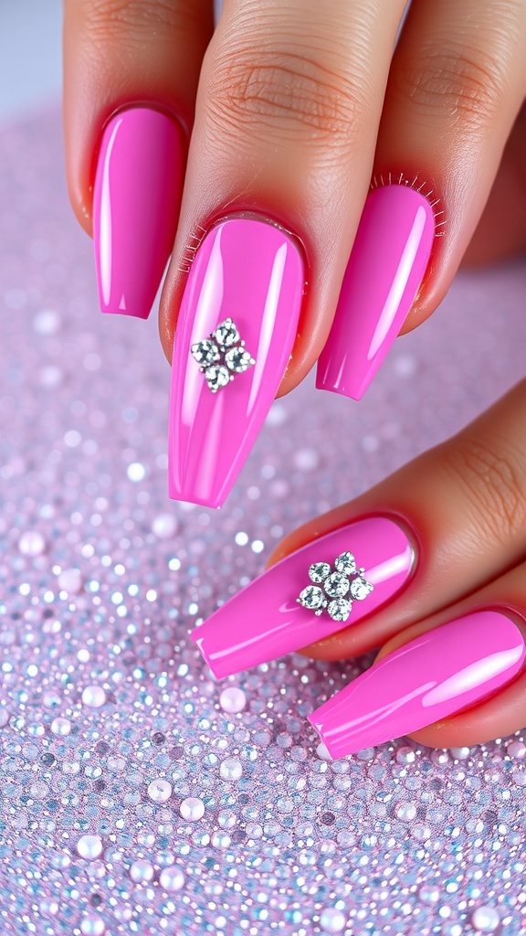 Close-up of pink chrome nails with rhinestone embellishments.