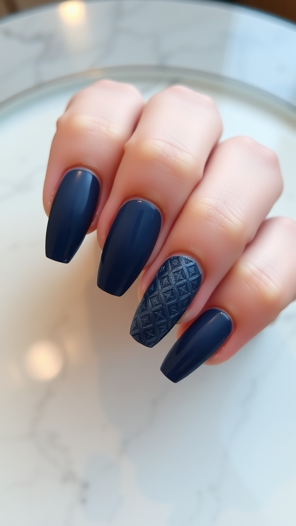 A hand with dark blue geometric patterned nails on a marble surface.